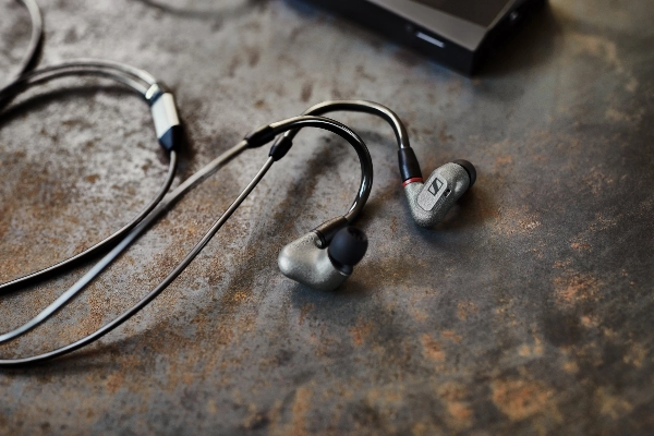 Black Sennheiser headphones on brown background 